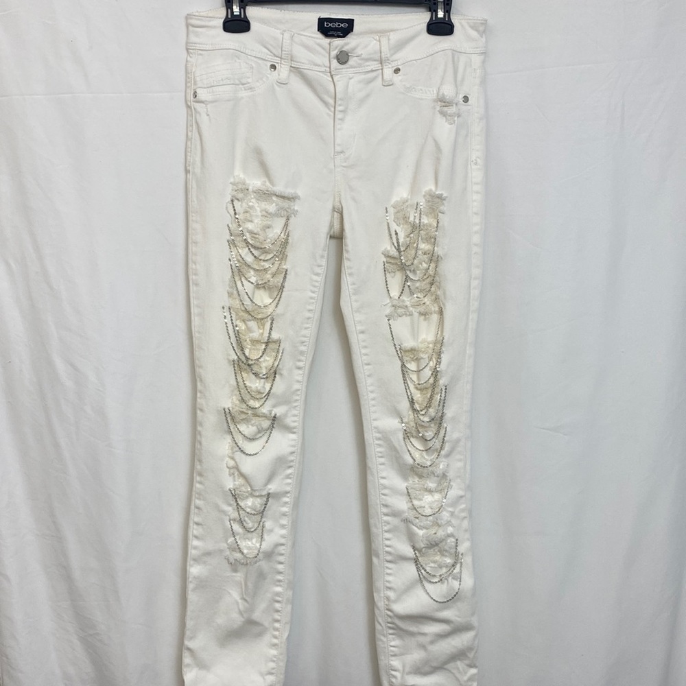 Bebe Women’s white jeans distressed in size 30.